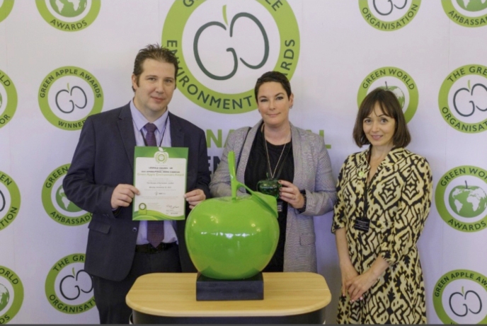 Representatives from Leopold Square receiving their Green Apple award